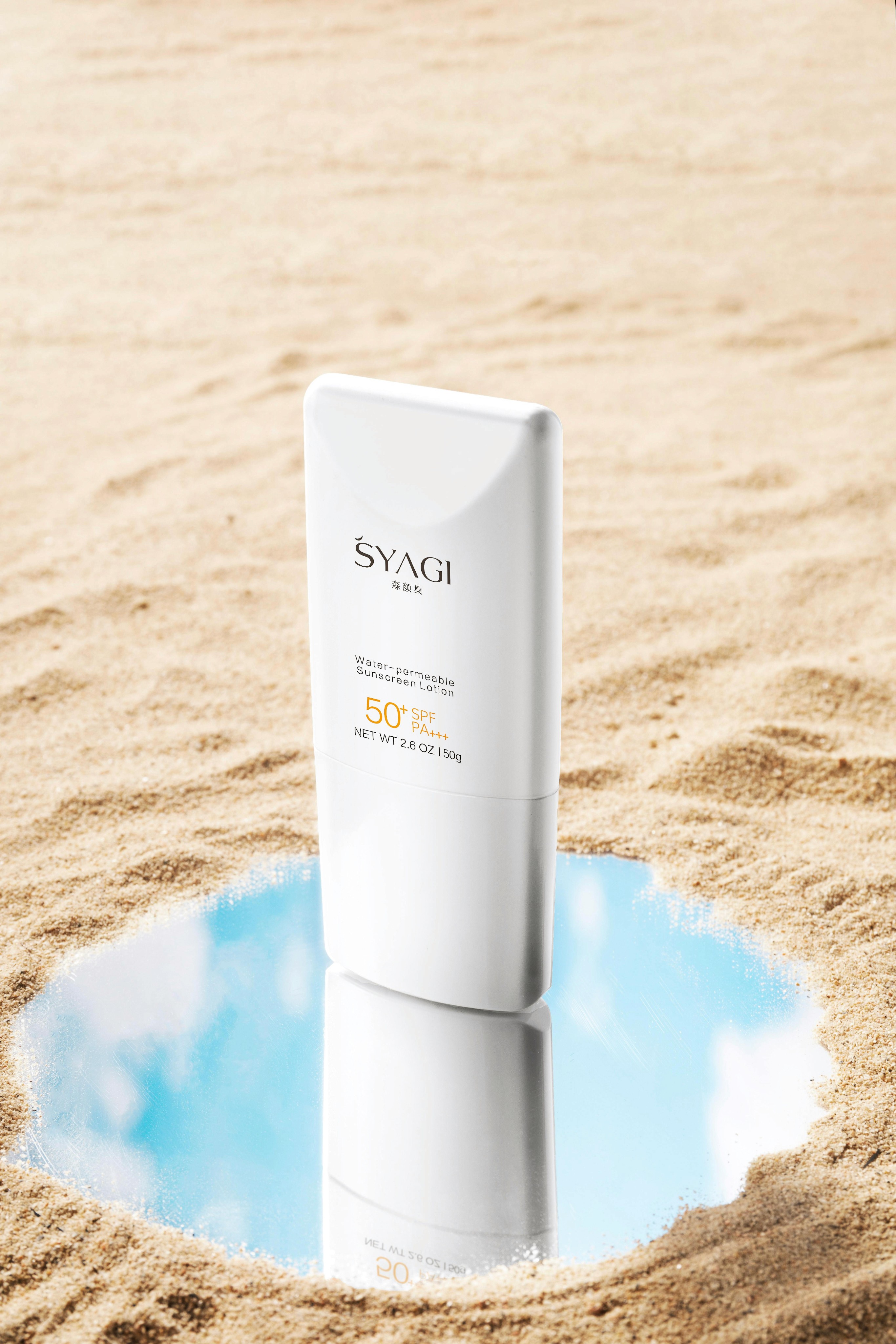 SYAGI SPF 50+ sunscreen lotion on sand
